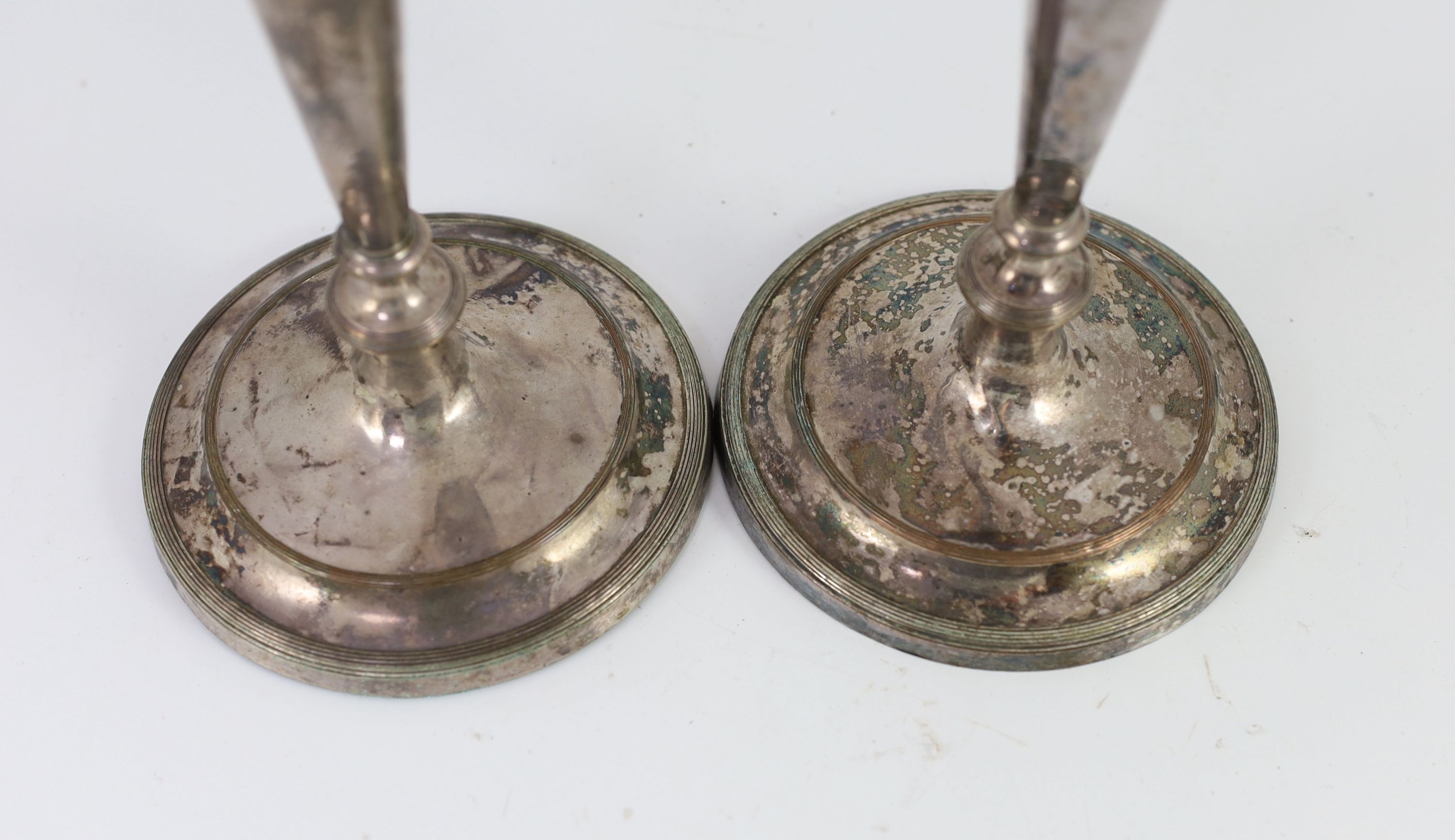 A pair of Sheffield plate candlesticks and nozzles, 26cm high